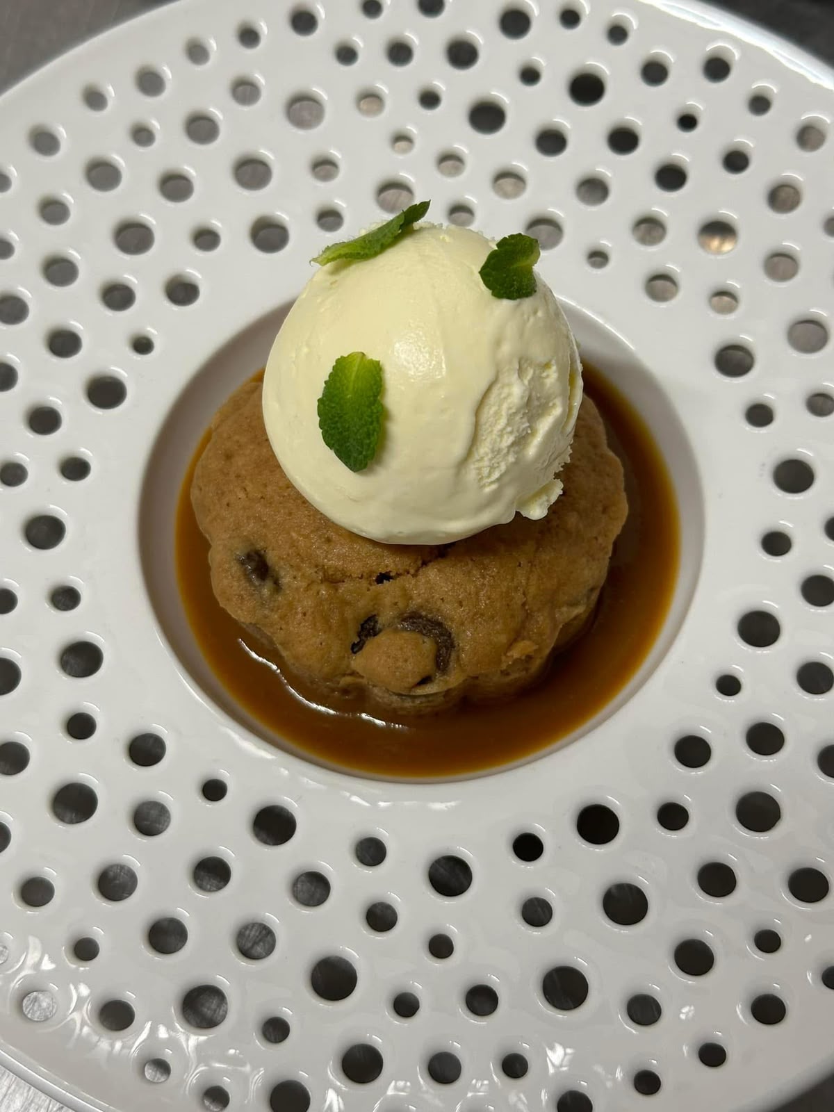 Warm chocolate chip cookie with ice cream and caramel