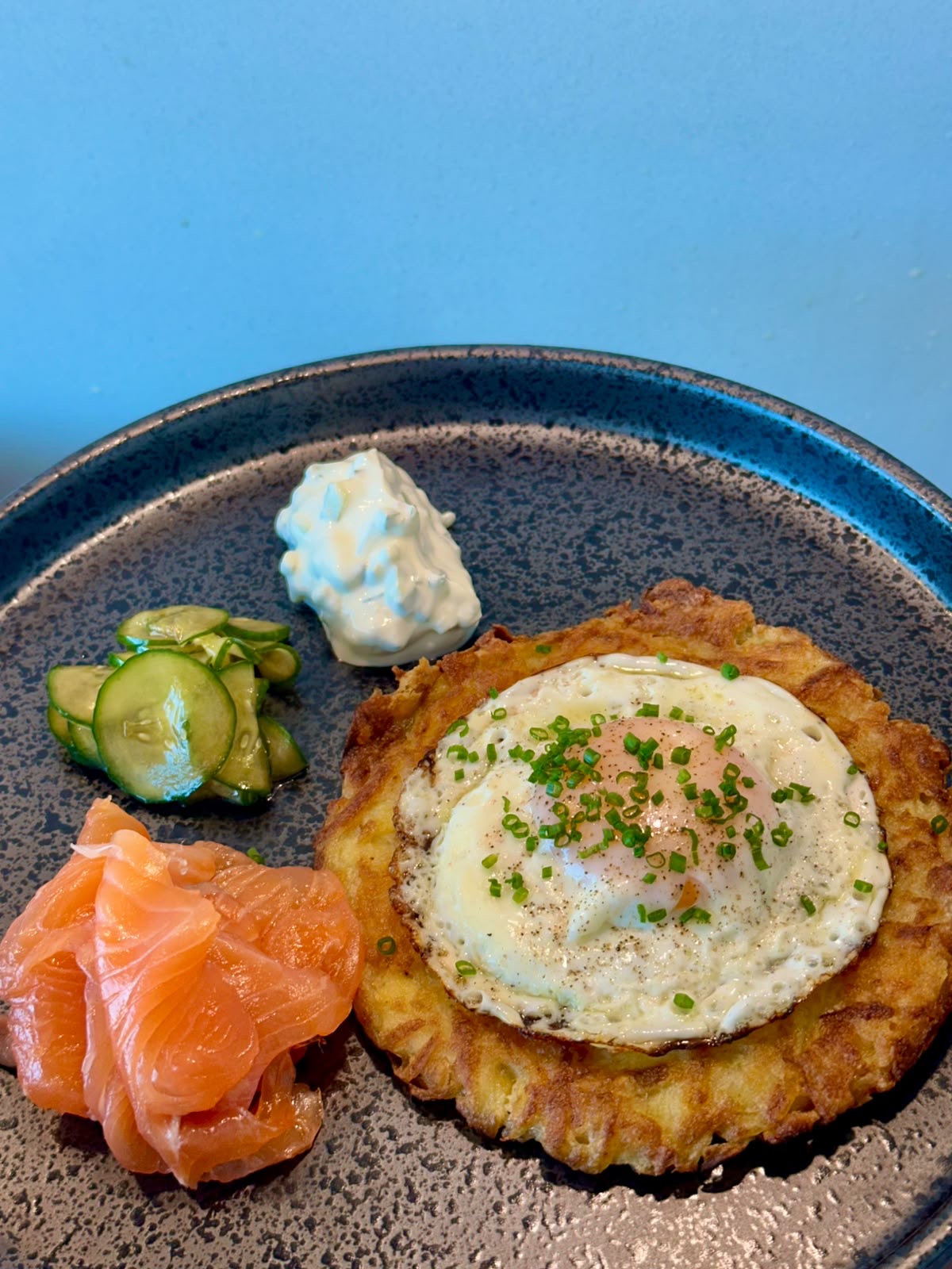 Crispy potato rösti topped with a fried egg and herbs